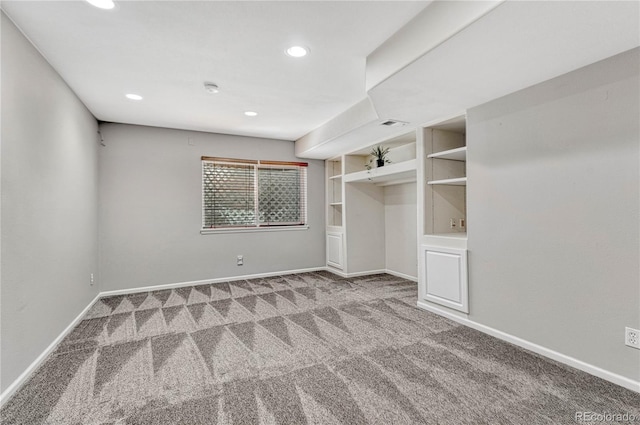 carpeted spare room with recessed lighting, built in features, and baseboards