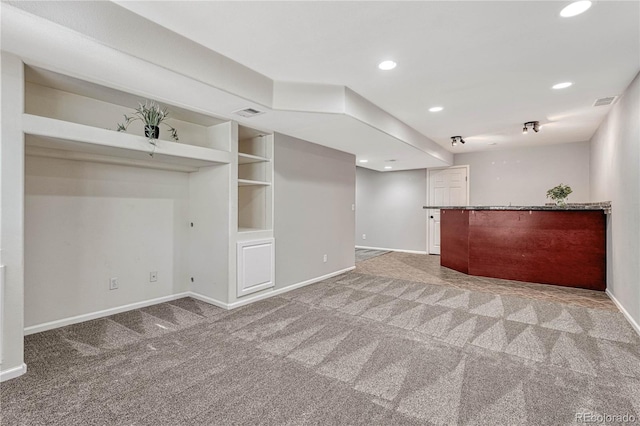 interior space with light carpet, built in shelves, baseboards, and recessed lighting