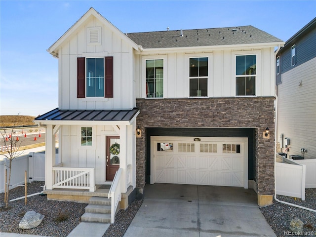 modern farmhouse style home featuring concrete driveway, board and batten siding, an attached garage, and stone siding