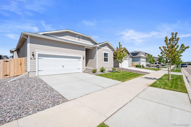 819 Sunflower Dr, Brighton, CO 80601 - ranch-style house with driveway and an attached garage