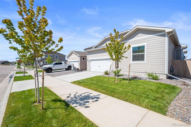 819 Sunflower Dr, Brighton, CO 80601 - view of front of property with driveway, an attached garage, and a residential view