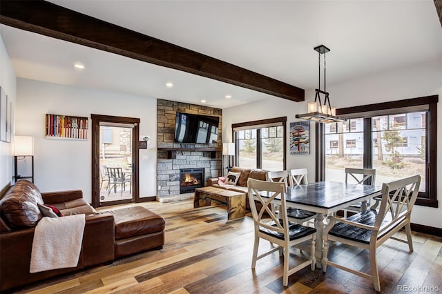 200 Quill, Fraser, CO 80442 - dining space with a fireplace, beamed ceiling, light wood-type flooring, recessed lighting, and baseboards
