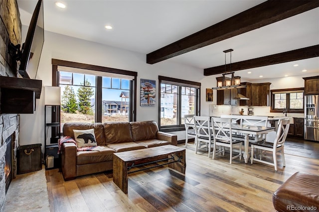 200 Quill, Fraser, CO 80442 - living room with plenty of natural light, wood-type flooring, beam ceiling, a fireplace, and recessed lighting