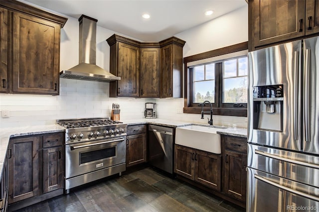 200 Quill, Fraser, CO 80442 - kitchen with appliances with stainless steel finishes, wall chimney range hood, a sink, dark brown cabinets, and tasteful backsplash