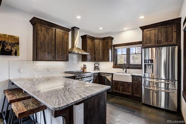 200 Quill, Fraser, CO 80442 - kitchen featuring stainless steel appliances, wall chimney range hood, a sink, dark brown cabinets, and recessed lighting