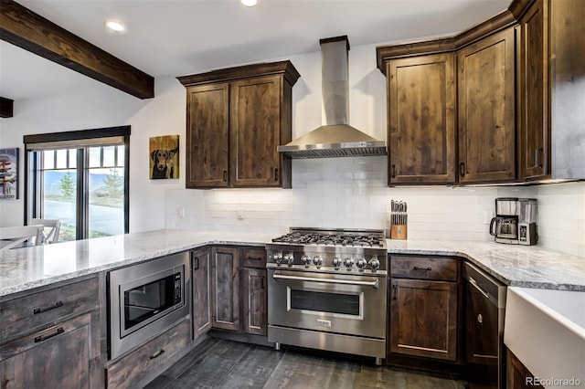 200 Quill, Fraser, CO 80442 - kitchen with appliances with stainless steel finishes, wall chimney range hood, light stone counters, beam ceiling, and dark brown cabinetry