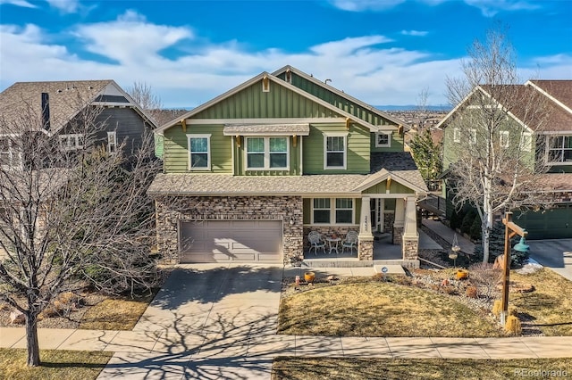 craftsman house featuring an attached garage, a shingled roof, concrete driveway, stone siding, and board and batten siding