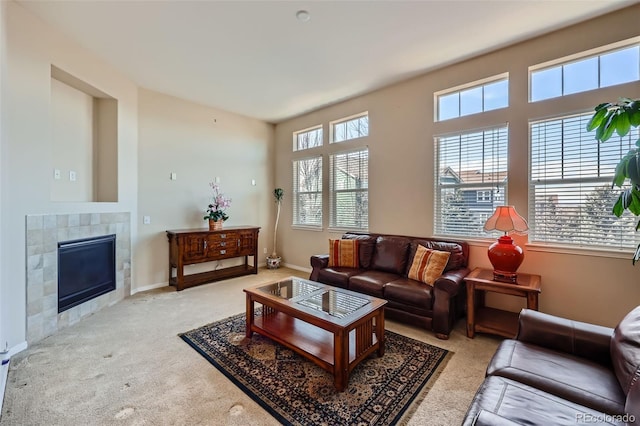 living area featuring carpet flooring, a fireplace, and baseboards