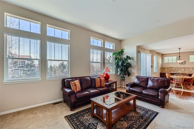 living room featuring visible vents, baseboards, and carpet floors