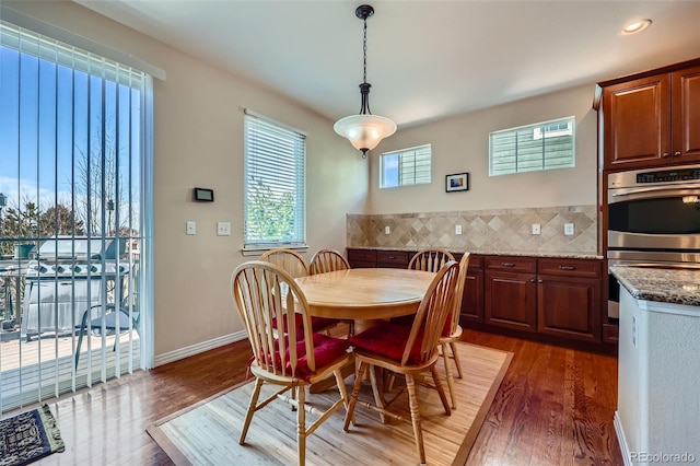 dining room featuring baseboards and wood finished floors