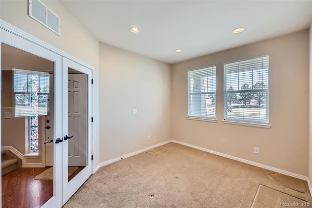 empty room with visible vents, light carpet, recessed lighting, french doors, and baseboards