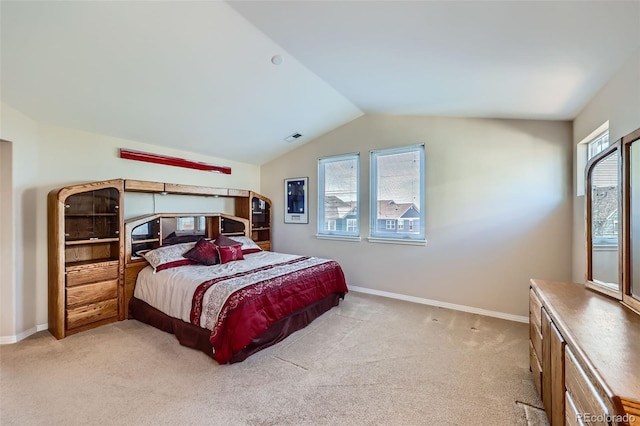 bedroom with baseboards, lofted ceiling, light colored carpet, and visible vents