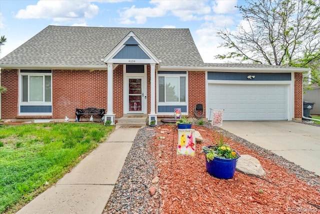 4694 S Ouray Way, Aurora, CO 80015 - view of front of home featuring brick siding, concrete driveway, a garage, and a shingled roof