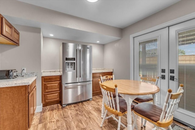 4694 S Ouray Way, Aurora, CO 80015 - kitchen featuring stainless steel refrigerator with ice dispenser, brown cabinets, light wood finished floors, and french doors