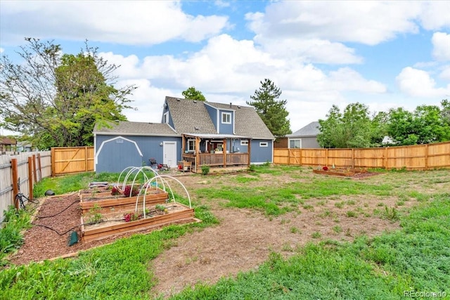 4694 S Ouray Way, Aurora, CO 80015 - back of property featuring a garden, a wooden deck, and a shingled roof