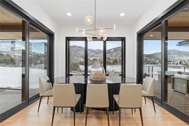 dining space featuring a mountain view, a notable chandelier, and plenty of natural light