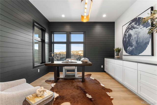 office featuring wooden walls and light hardwood / wood-style floors