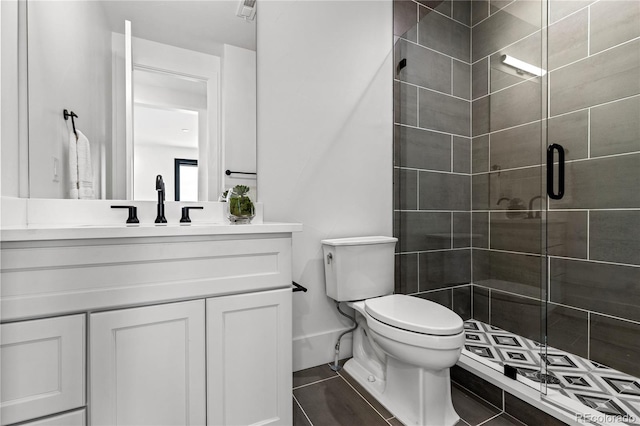 bathroom with vanity, toilet, and an enclosed shower