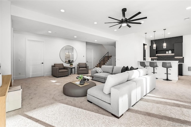 carpeted living room featuring ceiling fan