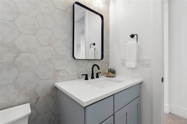 bathroom with vanity, tile walls, and toilet