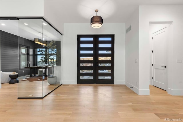 entryway featuring light hardwood / wood-style flooring and french doors