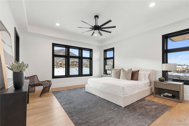 bedroom with ceiling fan and light hardwood / wood-style flooring