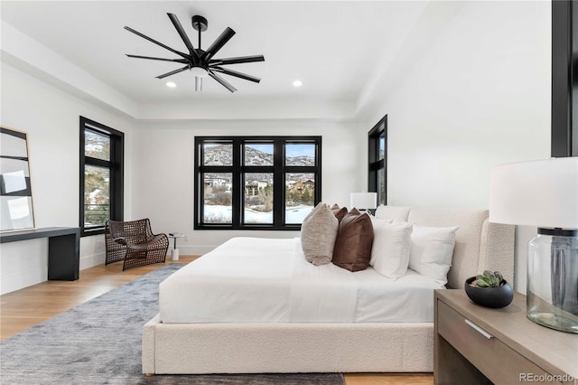 bedroom featuring recessed lighting, ceiling fan, light wood-style flooring, and baseboards