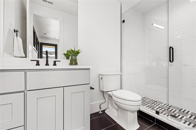 bathroom featuring vanity, toilet, an enclosed shower, and tile patterned flooring