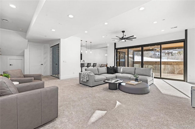 living room featuring light carpet and ceiling fan