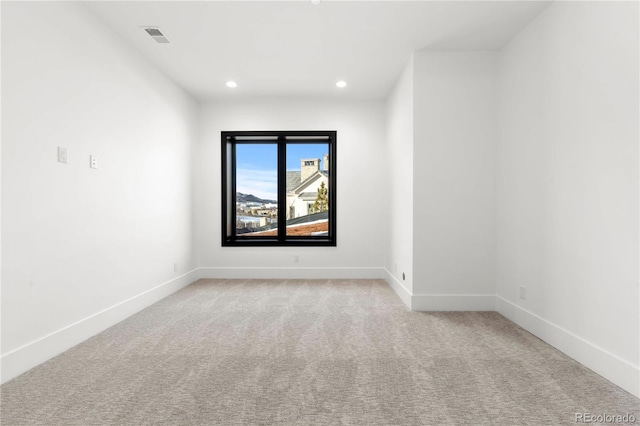 empty room with light carpet, baseboards, visible vents, and recessed lighting