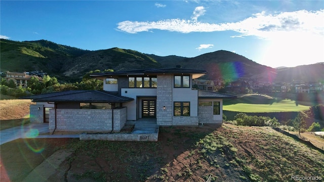 view of front of property with a mountain view and a patio