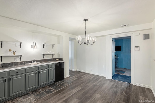 kitchen with gray cabinetry, dishwasher, sink, an inviting chandelier, and pendant lighting