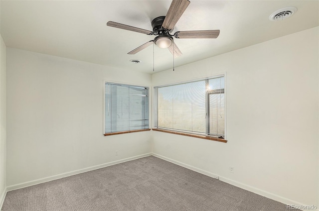 carpeted empty room featuring ceiling fan