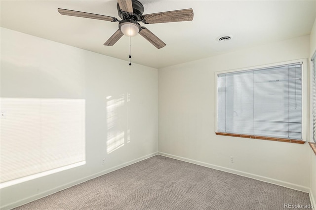 empty room with ceiling fan and light colored carpet