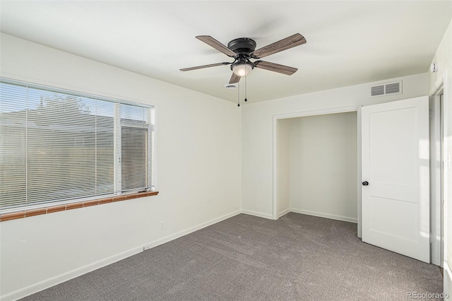 unfurnished bedroom featuring ceiling fan and carpet