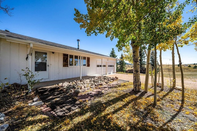 view of side of property with a garage