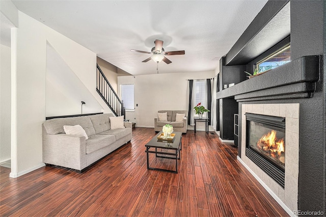 10289 Dresden St, Firestone, CO 80504 - living room with a fireplace, wood finished floors, a ceiling fan, and plenty of natural light