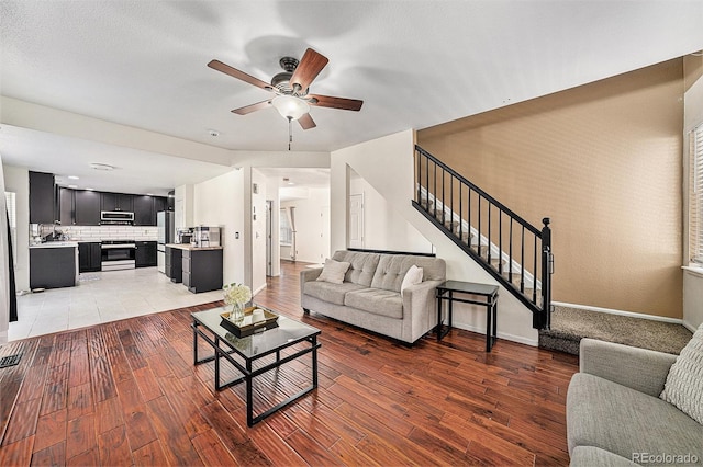 10289 Dresden St, Firestone, CO 80504 - living area with a ceiling fan, stairway, light wood finished floors, and baseboards