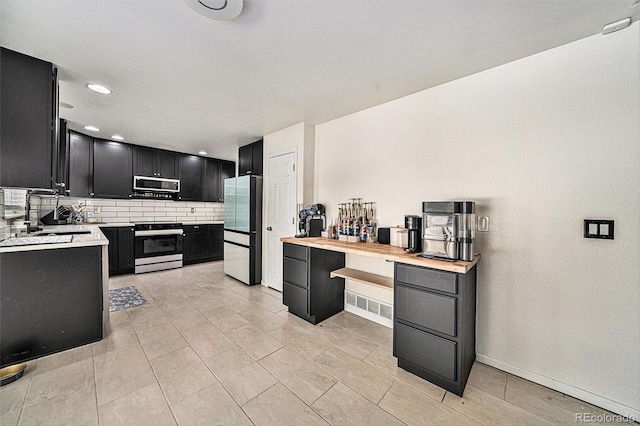 10289 Dresden St, Firestone, CO 80504 - kitchen with refrigerator, stainless steel microwave, dark cabinetry, electric range, and a sink