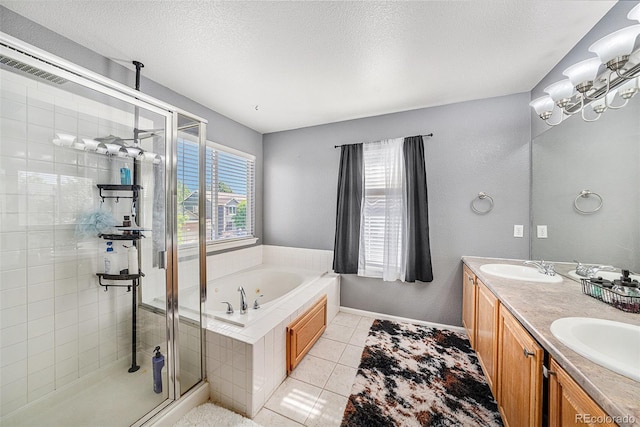 10289 Dresden St, Firestone, CO 80504 - bathroom featuring a stall shower, a bath, tile patterned flooring, double vanity, and a textured ceiling
