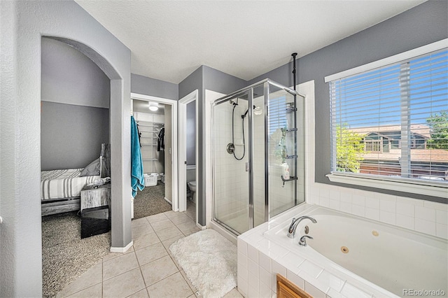 10289 Dresden St, Firestone, CO 80504 - bathroom featuring a shower stall, a tub with jets, toilet, and tile patterned flooring