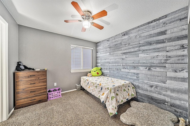10289 Dresden St, Firestone, CO 80504 - carpeted bedroom featuring a ceiling fan, wood walls, and baseboards