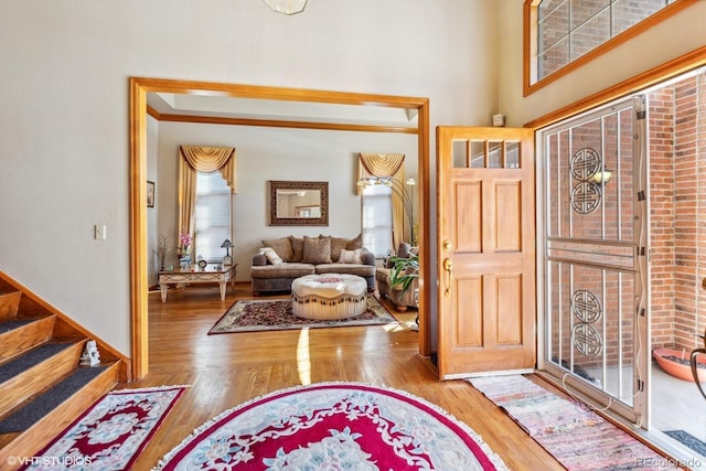 foyer entrance with stairway and wood finished floors