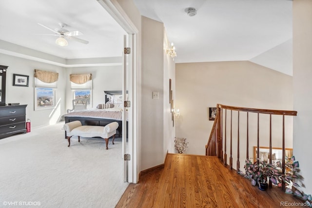 carpeted bedroom with lofted ceiling