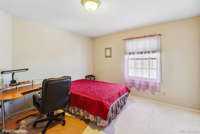 bedroom with carpet floors and baseboards