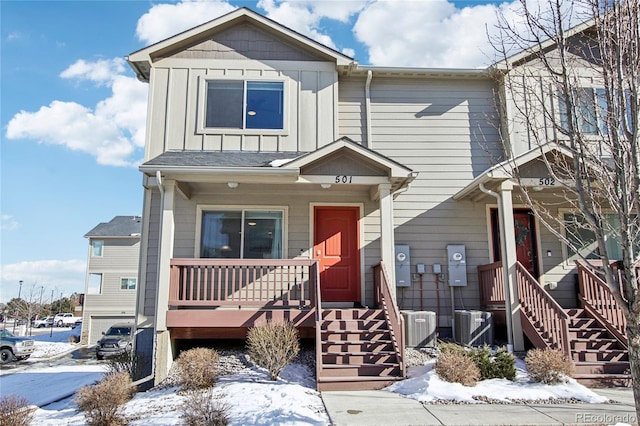 view of front of house with a garage and central air condition unit