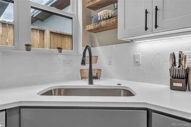 3219 W 19th Ave Unit 4, Denver, CO 80204 - kitchen featuring a sink, decorative backsplash, light countertops, stainless steel dishwasher, and open shelves