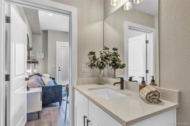 3219 W 19th Ave Unit 4, Denver, CO 80204 - bathroom with a textured wall, vanity, and wood finished floors