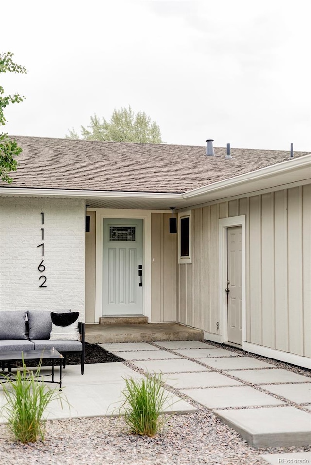 11762 W 34th Ave, Wheat Ridge, CO 80033 - doorway to property with board and batten siding and covered porch