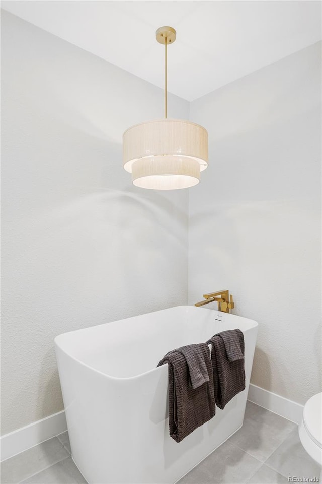 11762 W 34th Ave, Wheat Ridge, CO 80033 - bathroom featuring a freestanding bath, tile patterned floors, and baseboards
